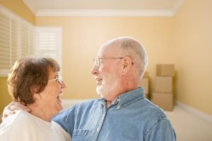 25107907 - happy senior couple in room with moving boxes on the floor.