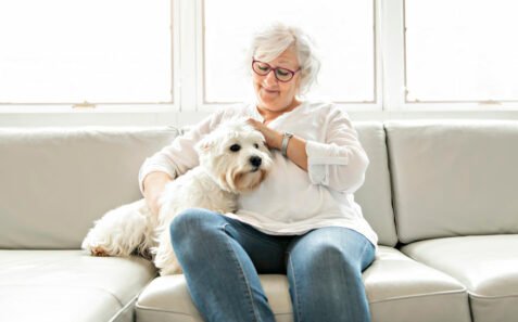 Pet therapy for seniors with elderly woman and dog.